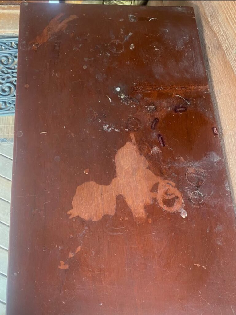 Top of the cabinet showing significant chemical and water damage