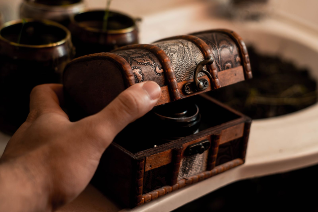 Leather treasure chest and hand opening it