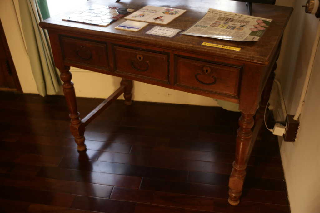 Solid wooden desk in the corner of a room