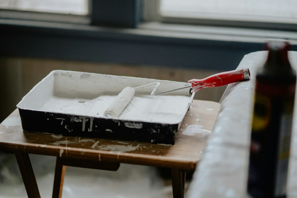 Paint tray and roller on a wooden table