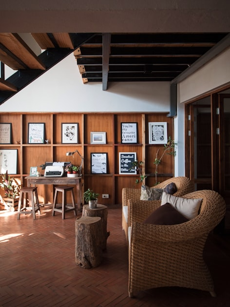 LIVING ROOM INTERIOR DESIGN WITH DESK AND TYPEWRITER, WOODEN WALLS, ART AND MCM/FARMHOUSE/INDUSTRIAL STYLE