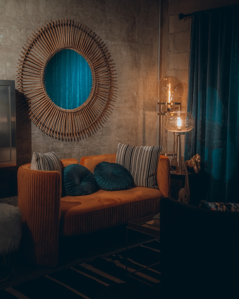 Moody eclectic room with different textures and orange sofa